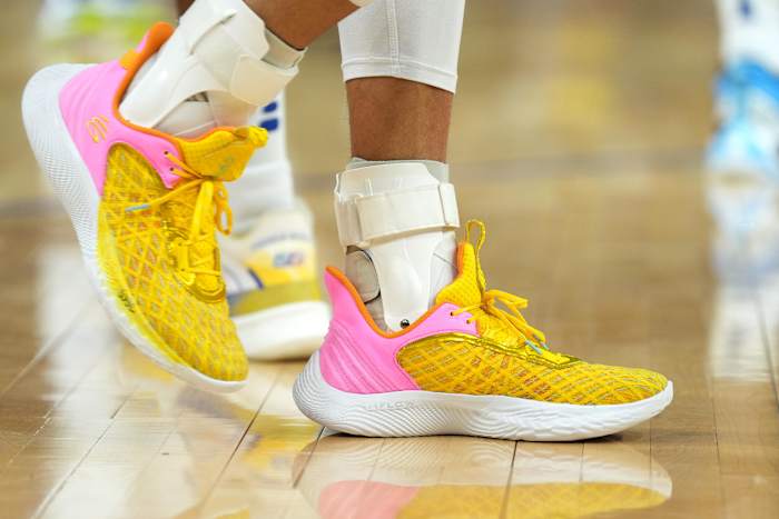 Golden State Warriors point guard Stephen Curry wearing the Sesame Street x Curry Flow 9 'Street Pack - Play Big'.